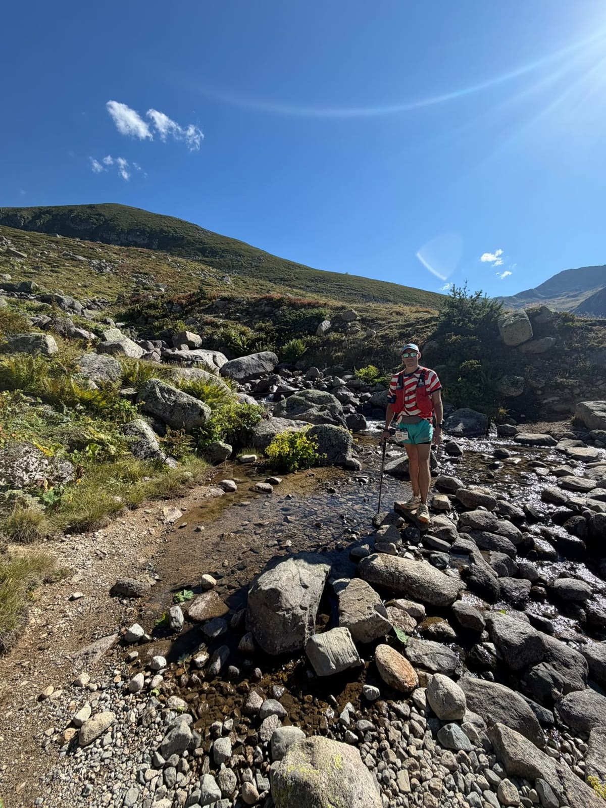 Zach Springer crossing a rocky river during the Kaçkar 50K